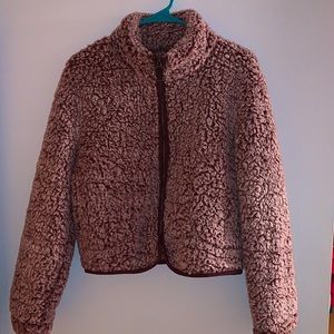 Small Fur jacket, zip up, 2 pockets and no hood.